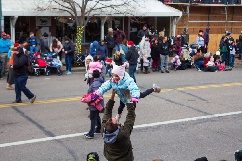 A spectator enjoys the aerial view of the Olde Golden Holiday Parade, Dec. 11.